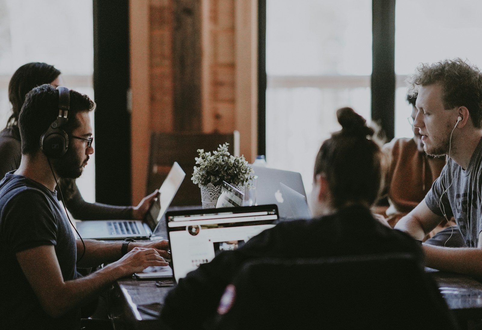 People working together around a shared table, photographed by Annie Spratt